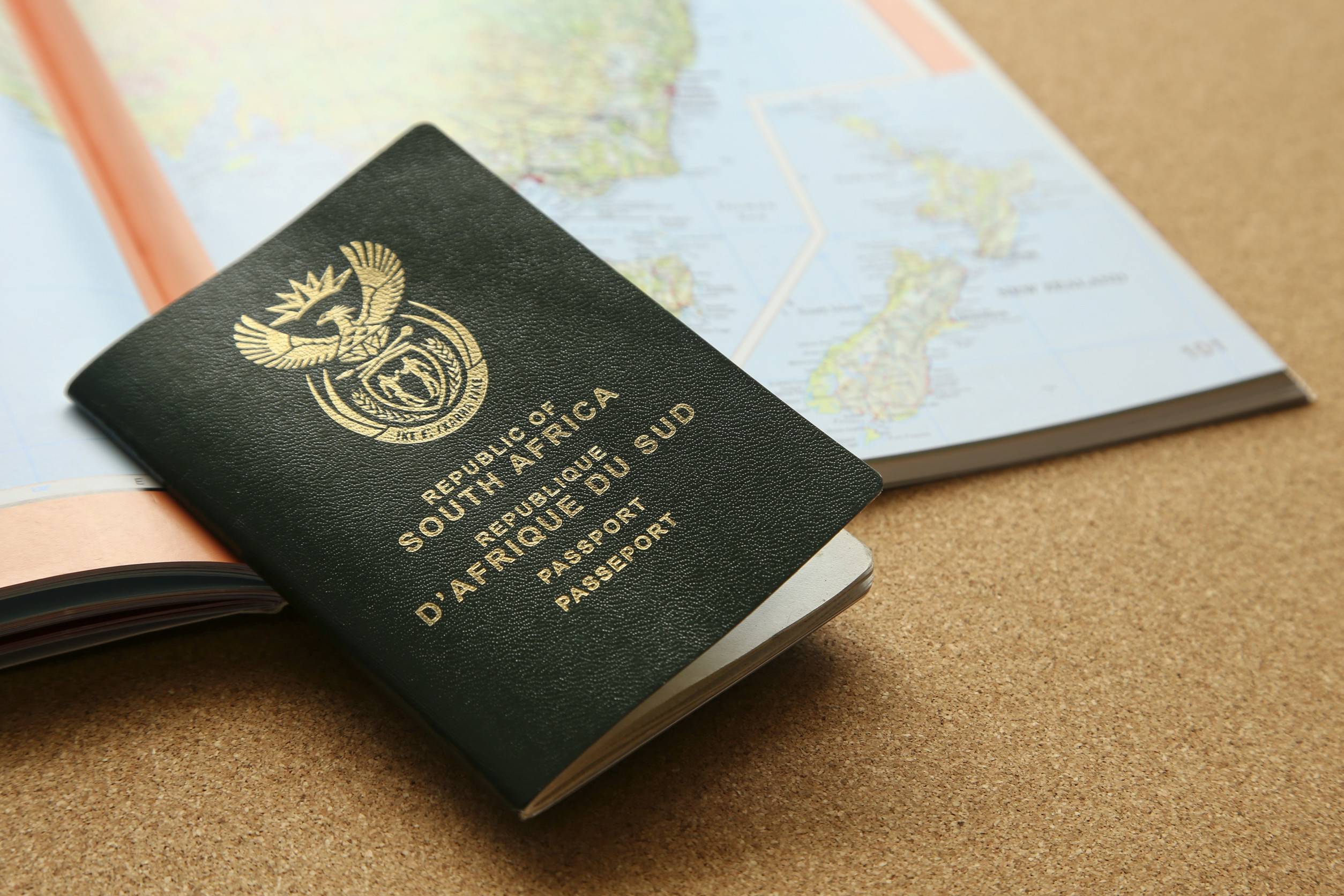 South African Passport Next To A World Map Travel And Emigration Concept